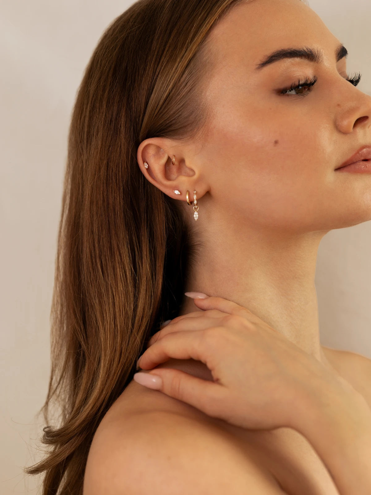 Model with 14K gold earrings on ear