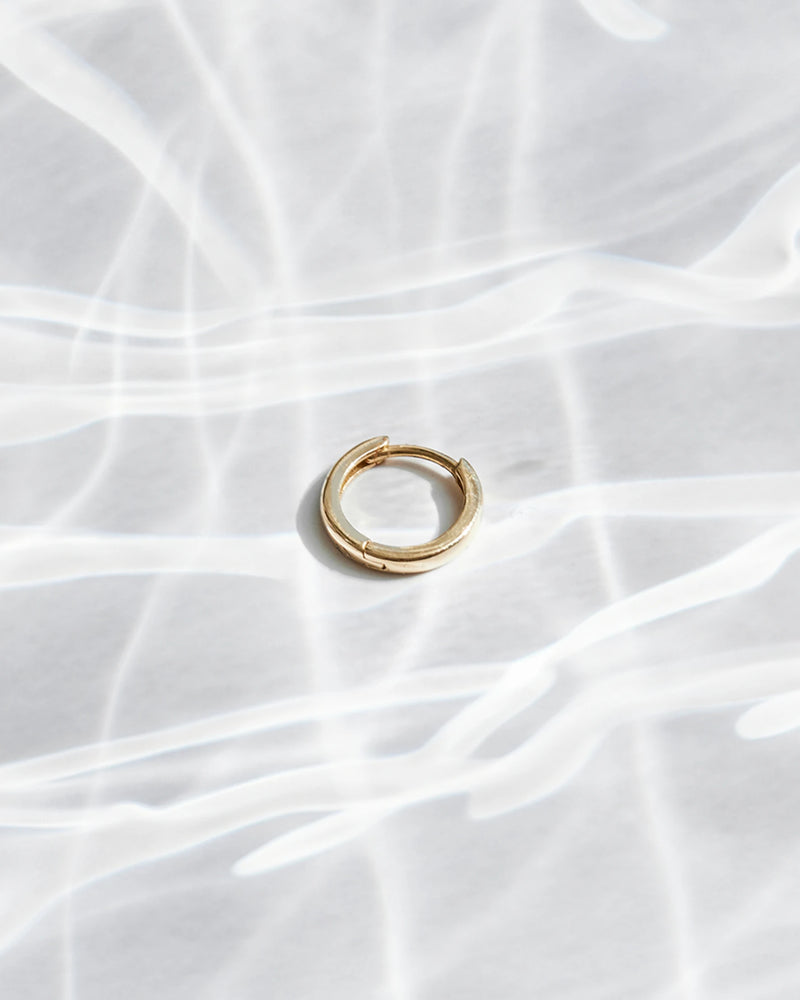 image_Gold Creole lies on a light-colored surface